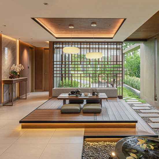 A warm, Japanese-inspired interior with a low wooden dining table, floor cushions, soft ambient lighting, and slatted wood partitions enhancing the serene atmosphere.